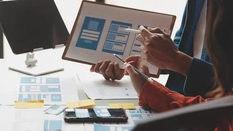 Close up ux developer and ui designer brainstorming about mobile app interf.. Stock Footage 236712878