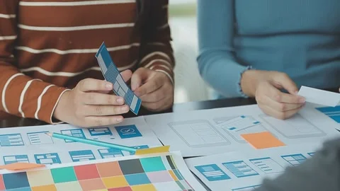 Close up ux developer and ui designer brainstorming about mobile app interf.. Stock Footage 236827955