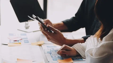 Close up ux developer and ui designer brainstorming about mobile app interf.. Stock Footage 236844555