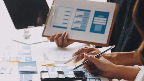 Close up ux developer and ui designer brainstorming about mobile app interf.. Stock Footage 236844556