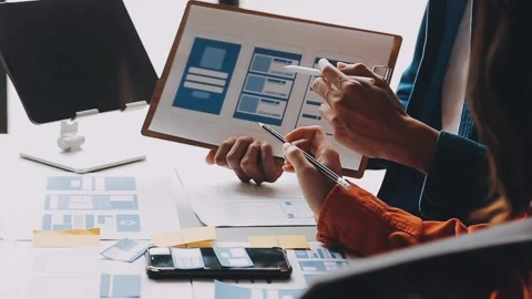 Close up ux developer and ui designer brainstorming about mobile app interf.. Stock Footage 236844565