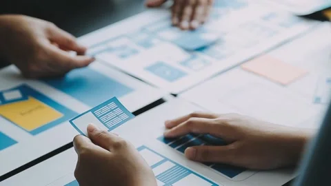 Close up ux developer and ui designer brainstorming about mobile app interf.. Stock Footage 236854164
