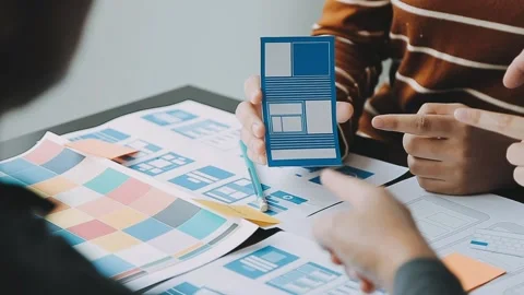 Close up ux developer and ui designer brainstorming about mobile app interf.. Stock Footage 236854166