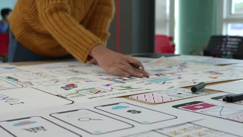 Close up ux developer and ui designer brainstorming interface wireframe design Stock Footage 243426896