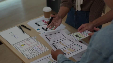 Close up ux developer and ui designer brainstorming interface wireframe design Stock Footage 243427070