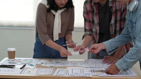 Close up ux developer and ui designer brainstorming interface wireframe design Stock Footage 243427146