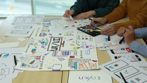 Close up ux developer and ui designer brainstorming interface wireframe design Stock Footage 243427188