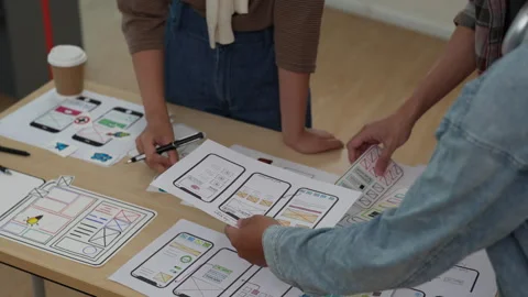 Close up ux developer and ui designer brainstorming interface wireframe design Stock Footage 244305202