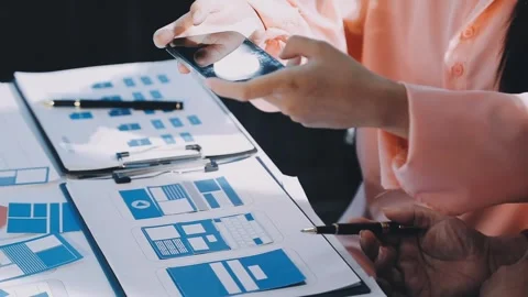 Close up ux developer and ui designer brainstorming about mobile app interf.. Stock Footage 293923265