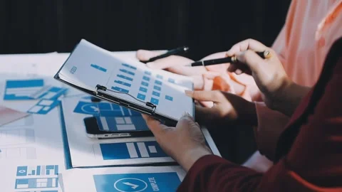 Close up ux developer and ui designer brainstorming about mobile app interf.. Stock Footage 293923300