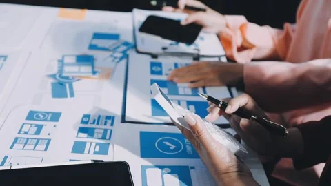 Close up ux developer and ui designer brainstorming about mobile app interf.. Stock Footage 293923309
