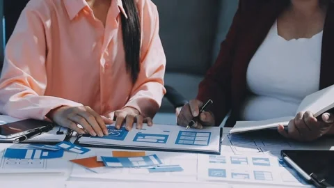 Close up ux developer and ui designer brainstorming about mobile app interf.. Stock Footage 293923322