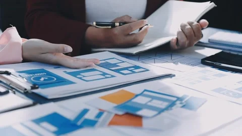 Close up ux developer and ui designer brainstorming about mobile app interf.. Stock Footage 293923328