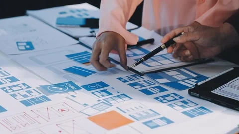 Close up ux developer and ui designer brainstorming about mobile app interf.. Stock Footage 293923358