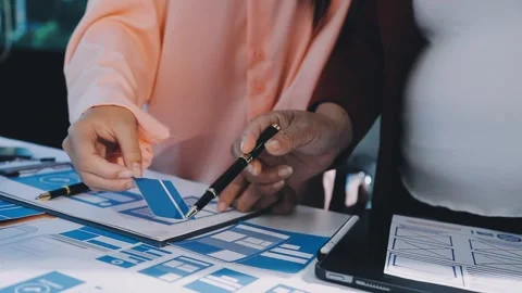 Close up ux developer and ui designer brainstorming about mobile app interf.. Stock Footage 293923367