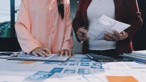 Close up ux developer and ui designer brainstorming about mobile app interf.. Stock Footage 293923370