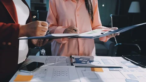Close up ux developer and ui designer brainstorming about mobile app interf.. Stock Footage 293923385