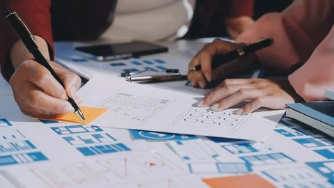 Close up ux developer and ui designer brainstorming about mobile app interf.. Stock Footage 293923403