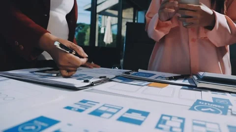 Close up ux developer and ui designer brainstorming about mobile app interf.. Stock Footage 293923434