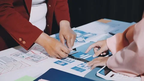 Close up ux developer and ui designer brainstorming about mobile app interf.. Stock Footage 293923444