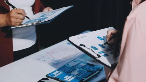 Close up ux developer and ui designer brainstorming about mobile app interf.. Stock Footage 293923497