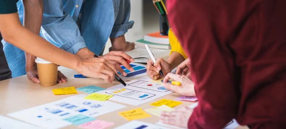 Close up ux developer and ui designer brainstorming about mobile app interfac Stock Photos