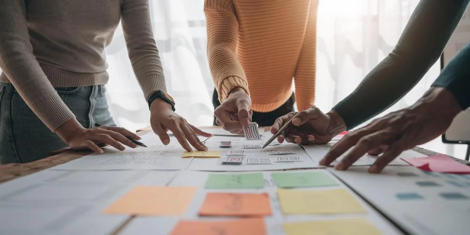 Close up ux developer and ui designer brainstorming about mobile app interface Foto stock