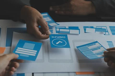 Close up ux developer and ui designer brainstorming about mobile app interf.. Stock Photos