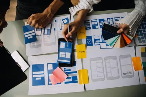 Close up ux developer and ui designer brainstorming about mobile app interf.. Stock Photos