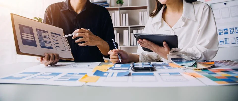 Close up ux developer and ui designer brainstorming about mobile app interf.. Stock Photos