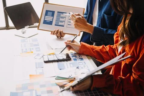 Close up ux developer and ui designer brainstorming about mobile app interf.. Stock Photos