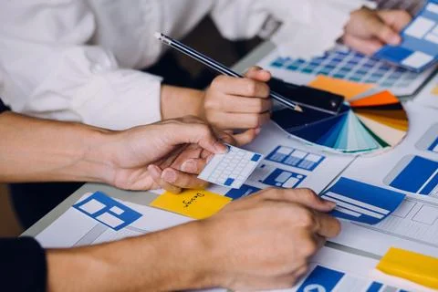 Close up ux developer and ui designer brainstorming about mobile app interf.. Stock Photos