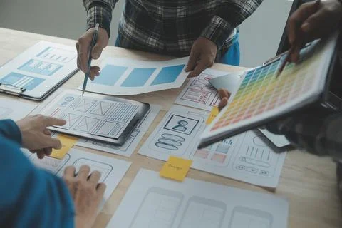 Close up ux developer and ui designer brainstorming about mobile app interf.. Stock Photos