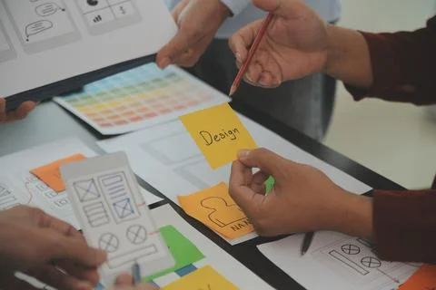 Close up ux developer and ui designer brainstorming about mobile app interf.. Stock Photos