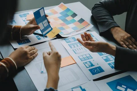 Close up ux developer and ui designer brainstorming about mobile app interf.. Stock Photos