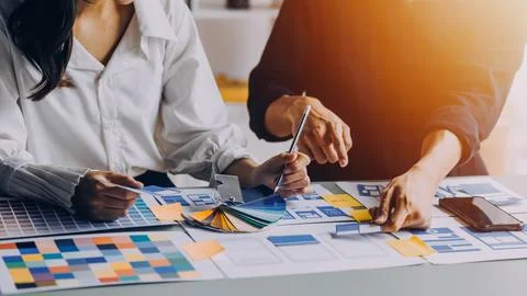 Close up ux developer and ui designer brainstorming about mobile app interf.. Stock Photos