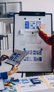 Close up ux developer and ui designer brainstorming about mobile app interf.. Stock Photos