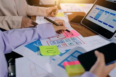 Close up ux developer and ui designer brainstorming about mobile app interf.. Foto stock