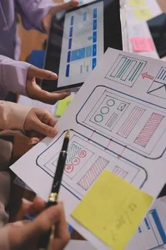 Close up ux developer and ui designer brainstorming about mobile app interf.. Foto stock