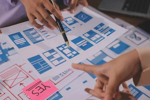 Close up ux developer and ui designer brainstorming about mobile app interf.. Stock Photos