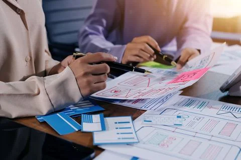 Close up ux developer and ui designer brainstorming about mobile app interf.. Foto stock