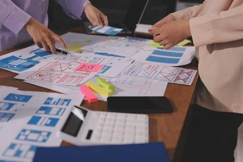 Close up ux developer and ui designer brainstorming about mobile app interf.. Foto stock