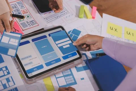 Close up ux developer and ui designer brainstorming about mobile app interf.. Stock Photos