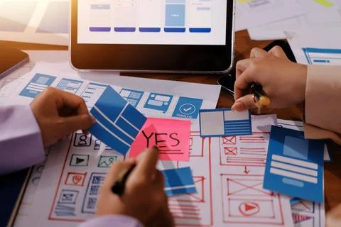 Close up ux developer and ui designer brainstorming about mobile app interf.. Stock Photos