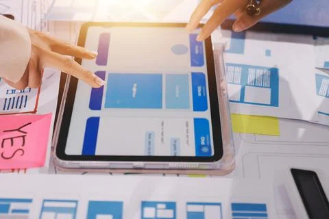 Close up ux developer and ui designer brainstorming about mobile app interf.. Foto stock