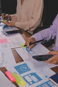 Close up ux developer and ui designer brainstorming about mobile app interf.. Foto stock