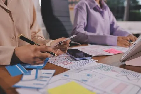 Close up ux developer and ui designer brainstorming about mobile app interf.. Foto stock