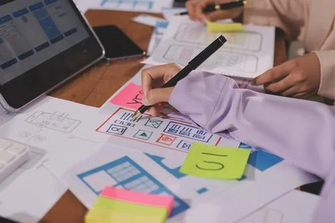 Close up ux developer and ui designer brainstorming about mobile app interf.. Foto stock