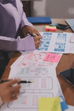 Close up ux developer and ui designer brainstorming about mobile app interf.. Foto stock