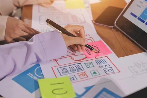 Close up ux developer and ui designer brainstorming about mobile app interf.. Foto stock